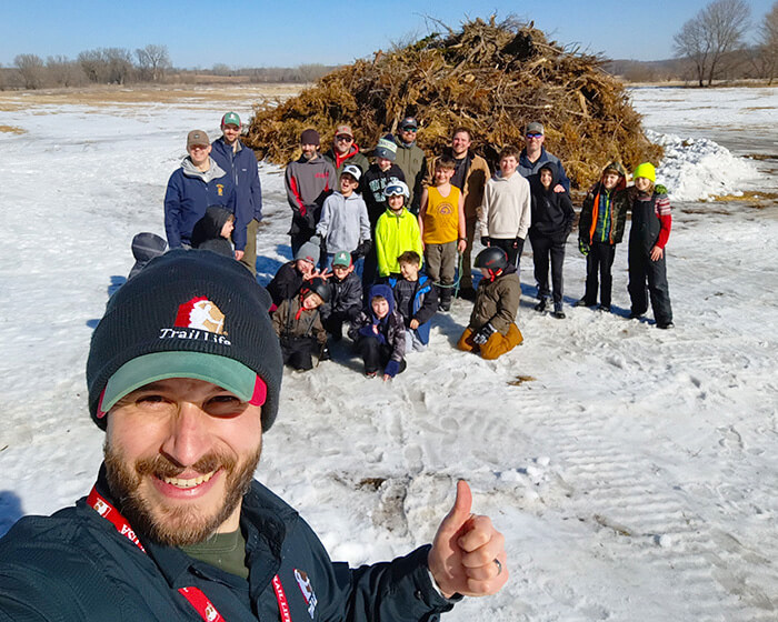 Jake Wattenphul founder of Troopmaster Times with his trail life troop during a winter snow bonfire