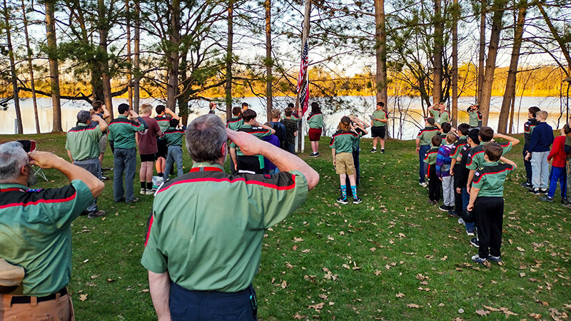 A Trail Life Troop event displaying a USA flag ceremony during camping weekend