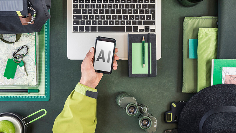 Hand holding a smartphone planning How AI can help run a better troop